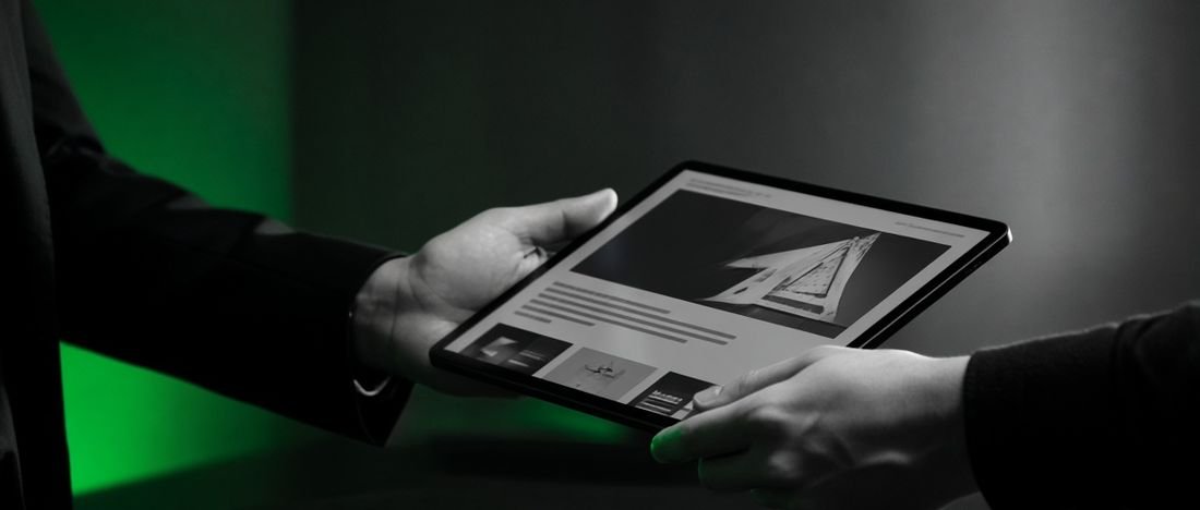 A tablet being handed over, representing a risky website handover
